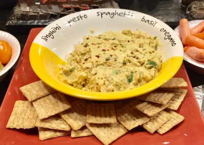 Hummus dip with Triscuits crackers on a red serving tray Mondays At Racine Mediterranean Foods Month with Wendy Kaplan RD