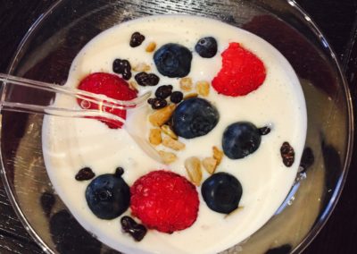 Bowl of yogurt with blueberries raspberries, nuts Mondays Monthly Glance- July August by Wendy Kaplan, RD