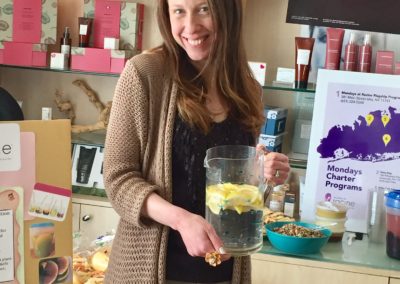 Wendy Kaplan, RD holding a pitcher of lemon infused water at Mondays At Racine event